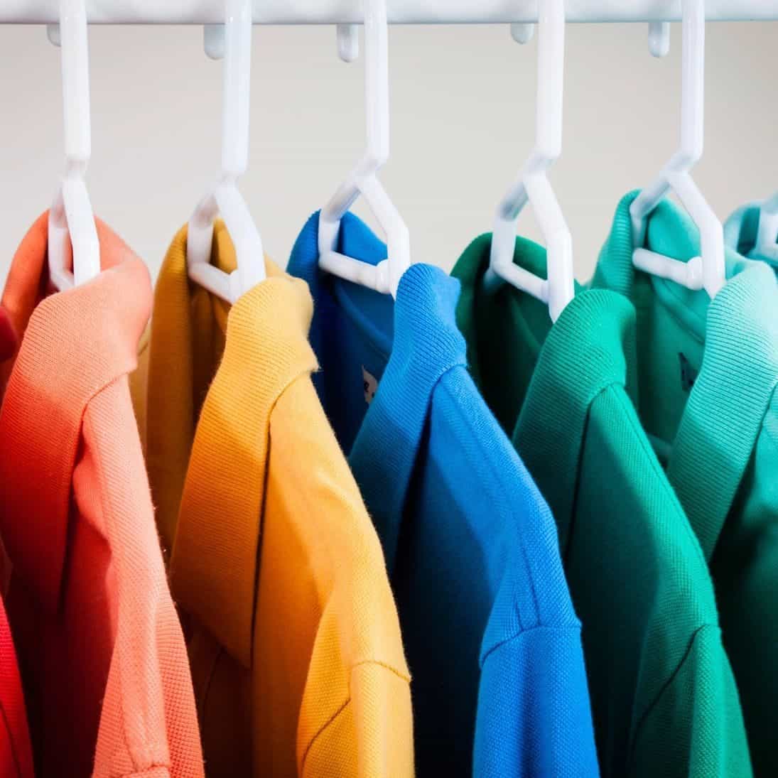 Colorful garments hanging on a rack at Foxboro Dry Cleaners